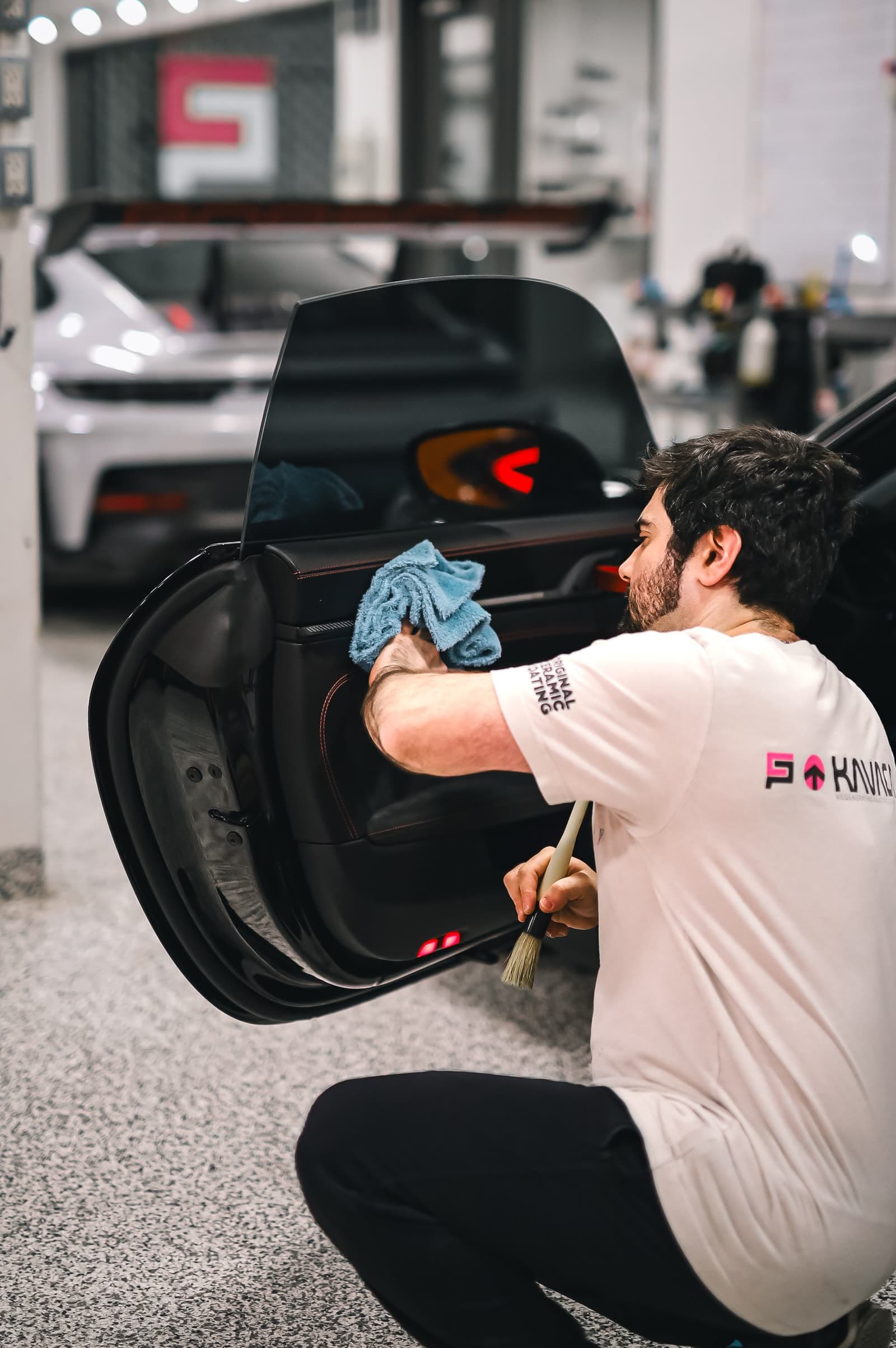 Detailer wiping a car door
