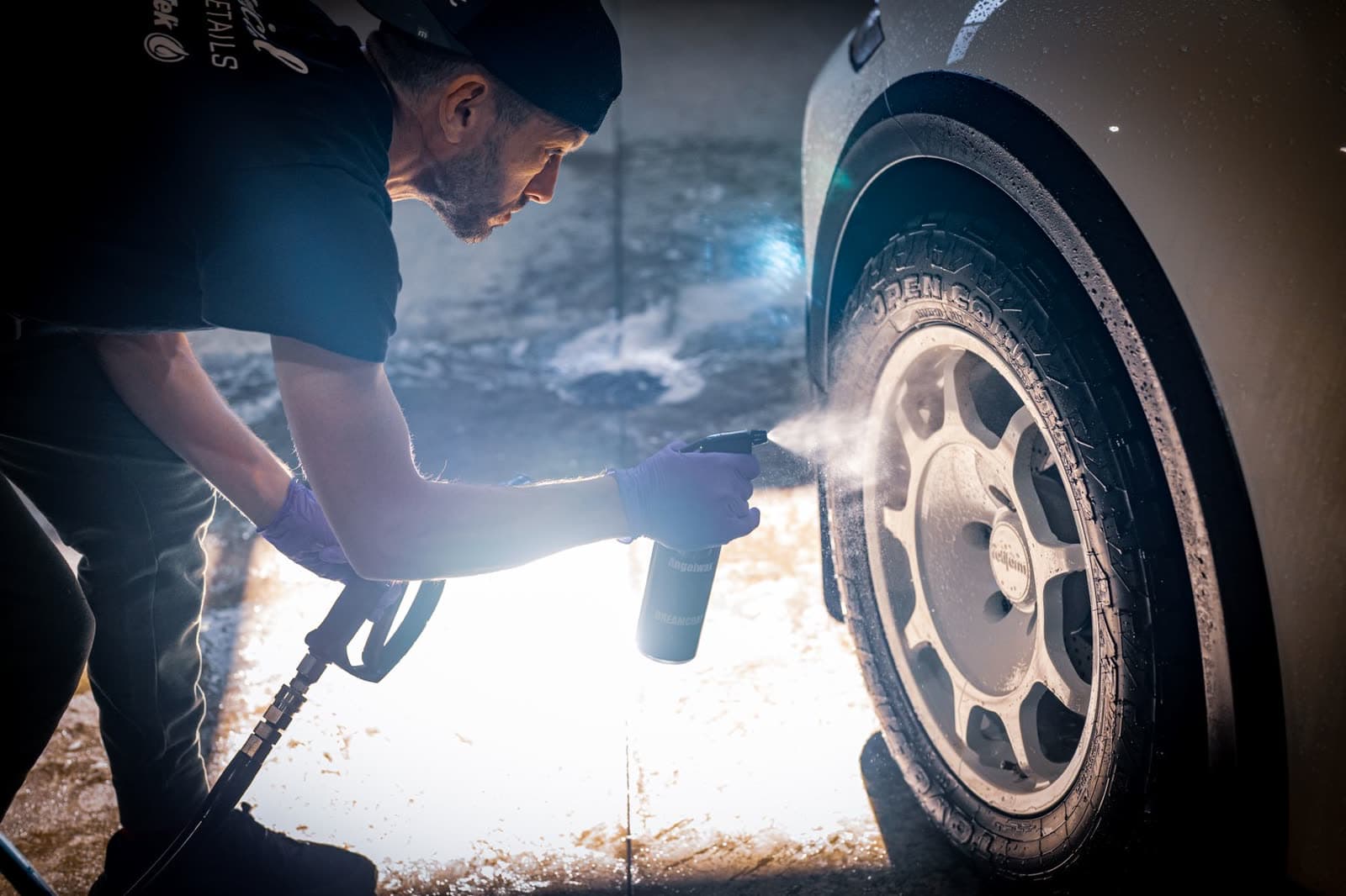 Detailer cleaning a wheel
